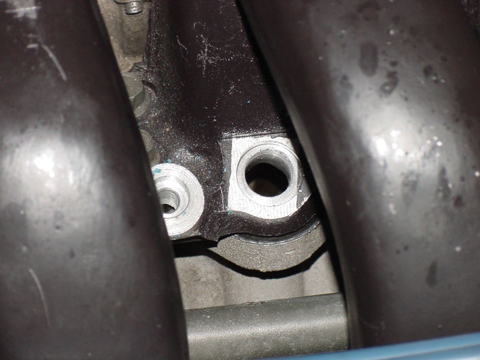 Close-up of a metal engine component with two circular openings
