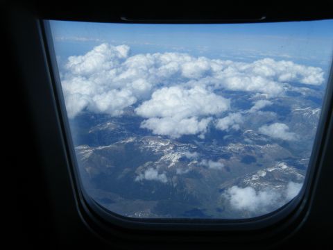 1981 Ford E350 - Looking down at mountains and clouds from an airplane window.