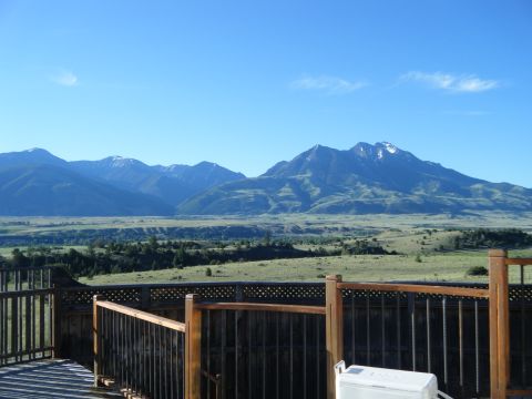 1981 Ford E350 - A scenic view of mountains and a valley from a wooden deck on a clear day.