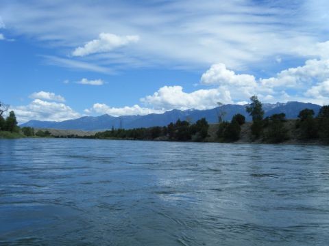 1981 Ford E350 - A scenic view of a river with mountains in the distance on a partly cloudy day.