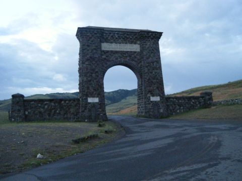 1981 Ford E350 - Stone archway entrance to a park, with text inscribed on the structure. The sky is cloudy.