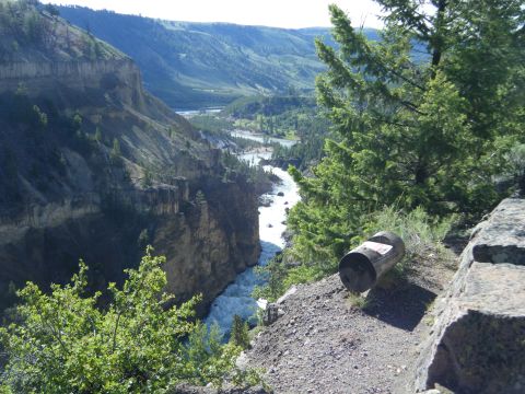 1981 Ford E350 - A trash can sits on the edge of a cliff overlooking a scenic river canyon.
