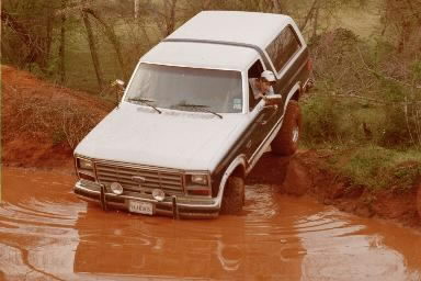 1986 Ford Bronco - This 1986 Ford Bronco navigates a muddy off-road trail.