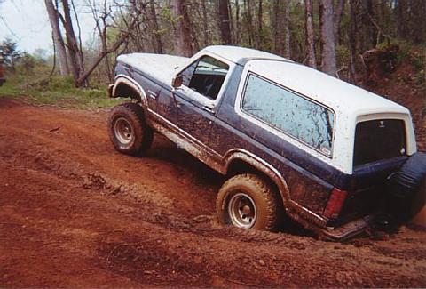 1986 Ford Bronco - This 1986 Ford Bronco is stuck deep in the mud on a wooded trail.