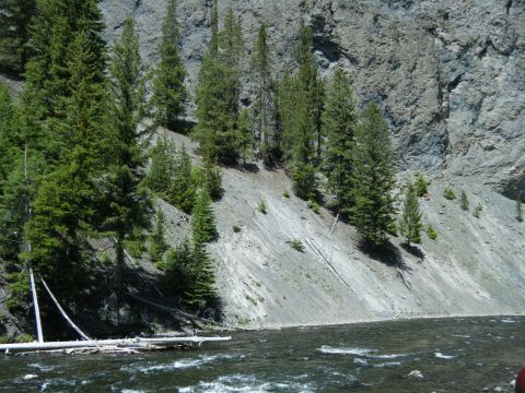 1981 Ford E350 - A scenic view of a river flowing through a rocky canyon, with pine trees dotting the hillside. The Supermotors.net logo is visible in the l…