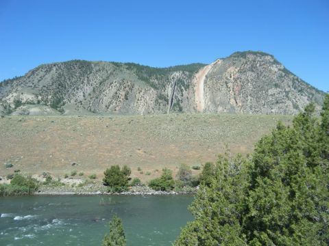 1981 Ford E350 - A scenic view of a mountain range and river, with the Supermotors.net logo in the lower right corner.