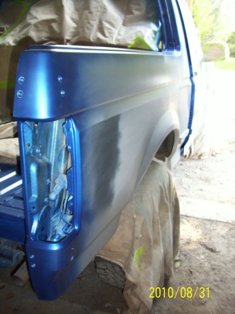 1993 Ford Bronco - The rear quarter panel of a blue 1993 Ford Bronco is shown during a repair process.