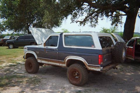 1986 Ford Bronco - This Ford Bronco has a two-tone paint scheme and a spare tire mounted on the back.