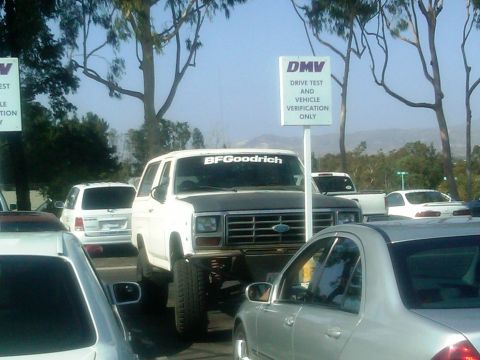 1986 Ford Bronco - This lifted Ford Bronco is parked at the DMV, possibly for vehicle verification.