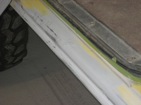 1978 Ford Bronco - Bodywork in progress on a vehicle's door sill, with a tire visible.