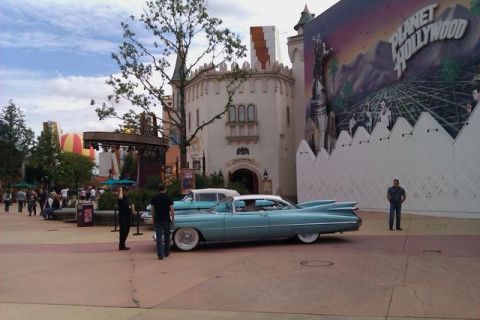 1991 Ford Crown Victoria - A classic 1959 Cadillac Eldorado is parked outside Planet Hollywood, with another vintage car behind it.