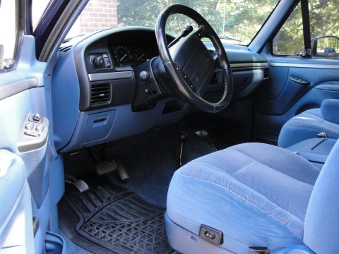 1967 Ford Mustang - Interior view of a blue truck, cloth seats and a dashboard with gauges.