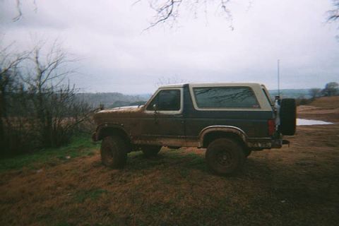 1986 Ford Bronco - This 1987 Ford Bronco appears to be set up for off-road use, with mud covering its body and large tires.