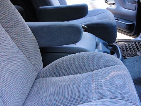 1967 Ford Mustang - Interior view of a vehicle blue cloth bucket seats and armrests. The "SUPERMOTORS" logo is visible in the lower right corner.