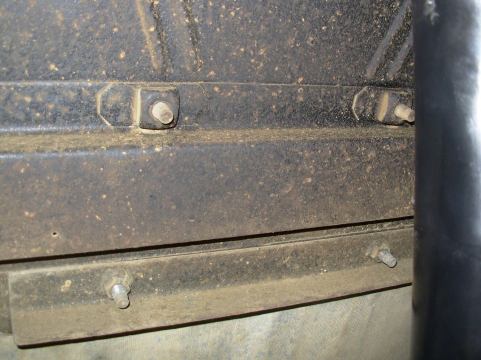 The angle iron with welded nuts is for the later shoulder belt buckles.  The stock eB location was too far forward for them to be effective, so the holes are plugged with the original bolts.  They'll also be used to attach a floor console.