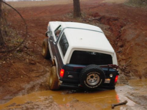1986 Ford Bronco - This 1986 Ford Bronco navigates a muddy off-road trail, its capability.