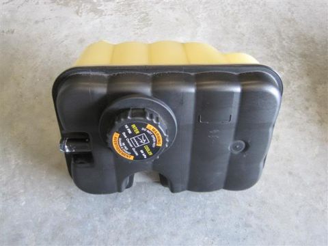 2007 Ford Mustang - This coolant reservoir has a warning label indicating 'Do Not Open When Hot' and pressure limits.