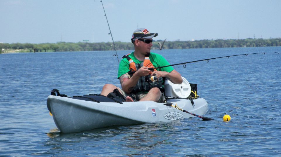 Man fishing from a kayak on a lake