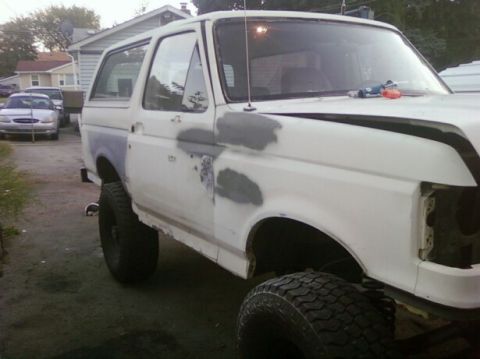 1989 Ford Bronco - This 1989 Ford Bronco is shown during body work, with primer and filler visible on its exterior panels.