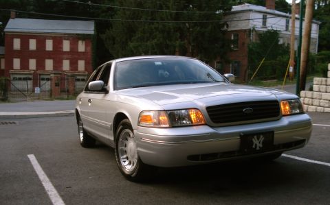 2000 Ford Crown Victoria - Front 3/4 view of a silver 2000 Ford Crown Victoria parked outdoors.
