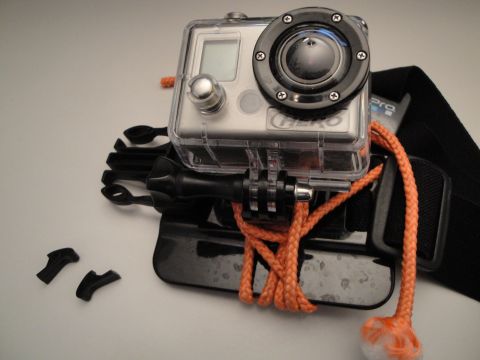 1993 Ford Taurus - A GoPro Hero camera is shown mounted with accessories, including a waterproof case and orange rope.