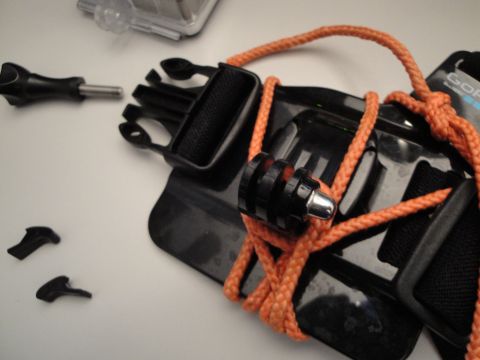 1993 Ford Taurus - GoPro camera mount accessories including a chest strap and several small plastic connectors.