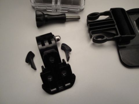 1993 Ford Taurus - Various black plastic camera mounting accessories are arranged on a light-colored surface.