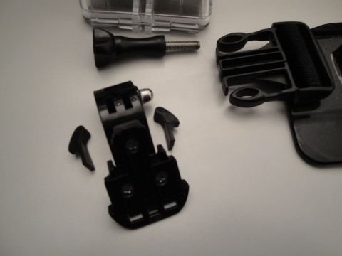 1993 Ford Taurus - Various black plastic camera mounting accessories and a clear case are laid out on a white background.