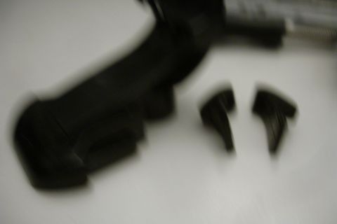 1993 Ford Taurus - Two black camera mount clips are shown on a white surface.