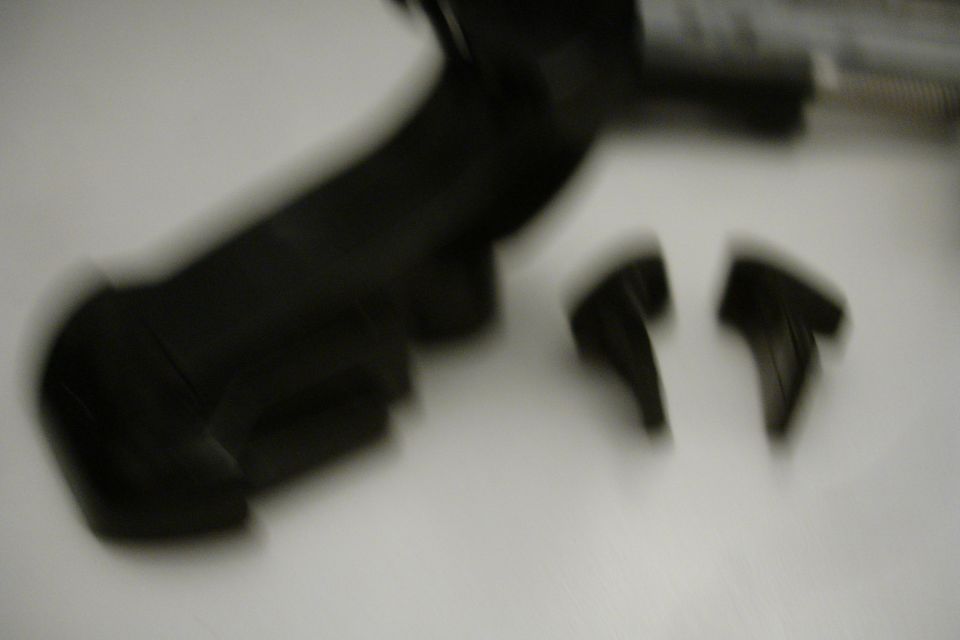 Two black camera mount clips on a white surface