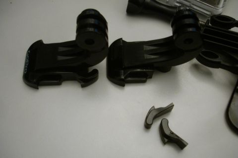 1993 Ford Taurus - A collection of black GoPro mounting accessories are laid out on a flat surface.
