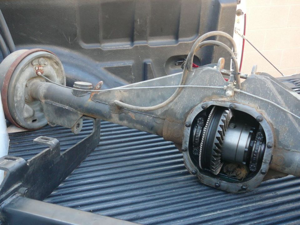 Rear axle assembly with differential exposed, sitting in truck bed
