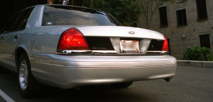 2000 Ford Crown Victoria - Rear view of a silver 2000 Ford Crown Victoria sedan with chrome accents and tinted windows.