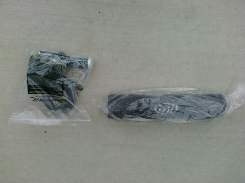 1997 Ford Probe - Two automotive parts are shown in their original plastic packaging on a textured surface.