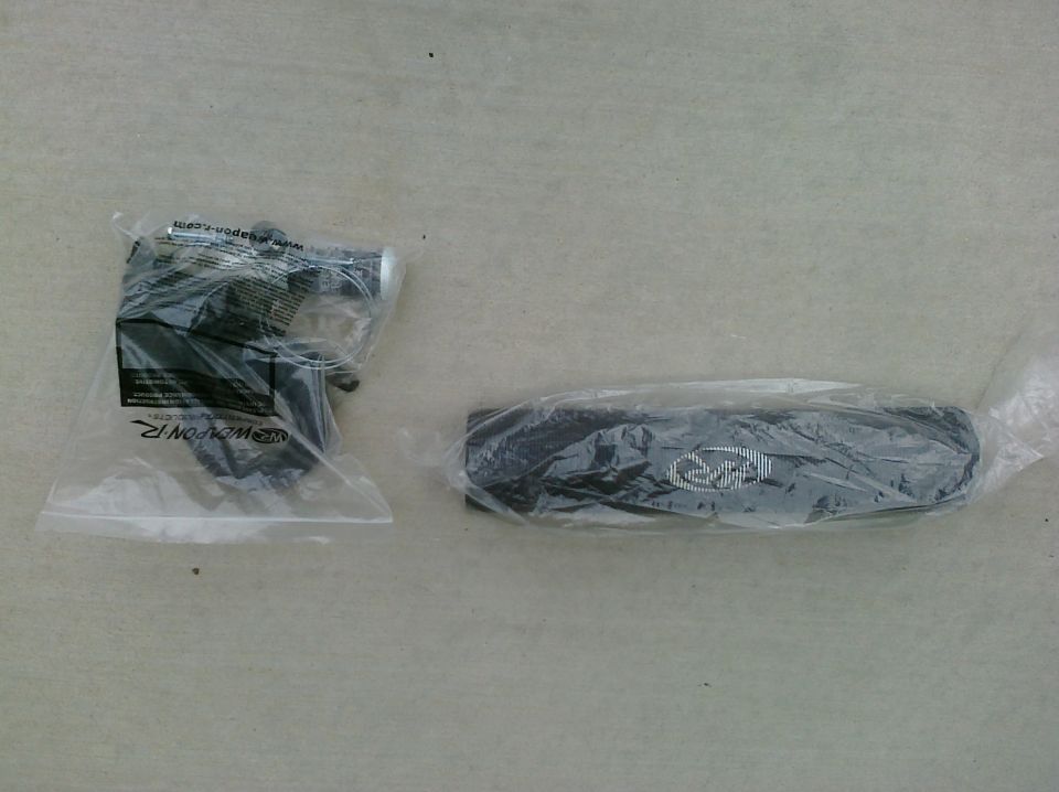 Two automotive parts in plastic packaging, one with a logo