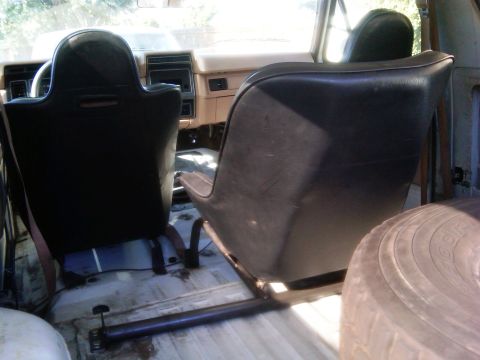 1986 Ford Bronco - Interior view of a 1986 Ford Bronco, highlighting the front seats and the open rear cabin space.