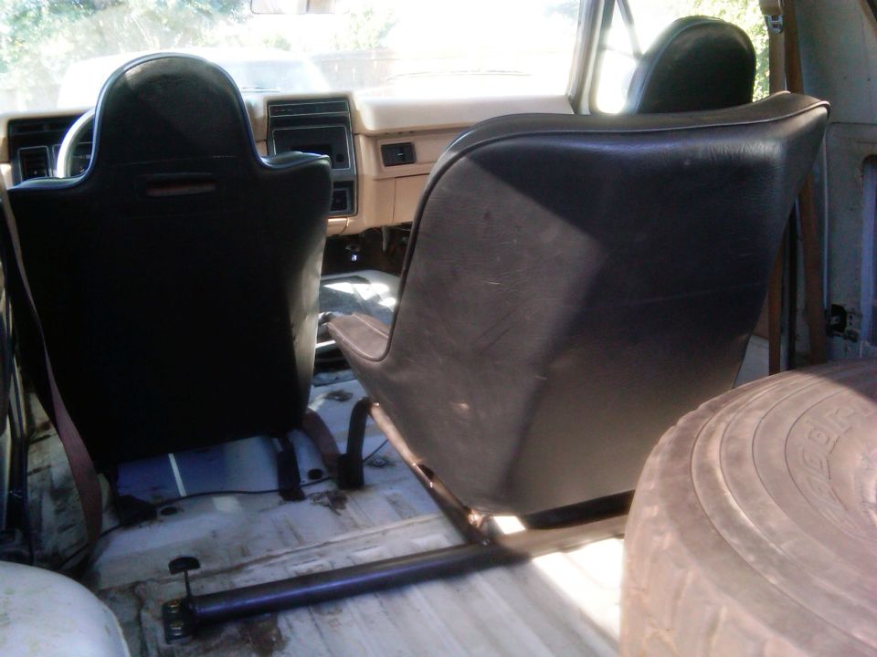 1986 Ford Bronco interior showing front bucket seats and rear bench seat area