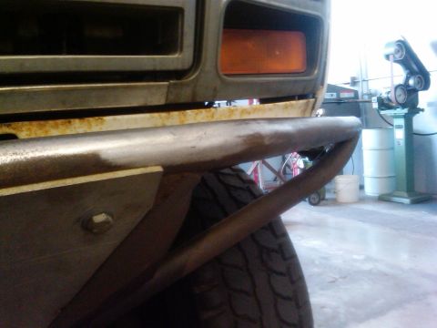 1986 Ford Bronco - Custom bumper installation on a vehicle, showing detail of the metalwork and some rust.