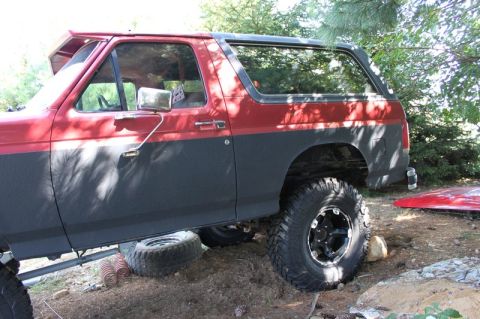 1987 Ford Bronco - This 1987 Ford Bronco is equipped with large off-road tires and appears to be undergoing modifications.