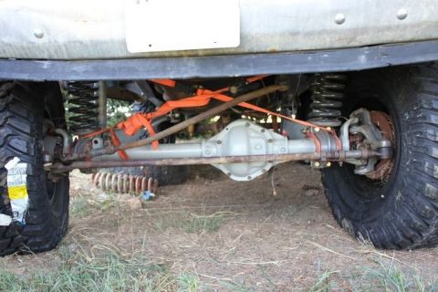 1987 Ford Bronco - Close-up of an off-road vehicle's front axle and suspension system.