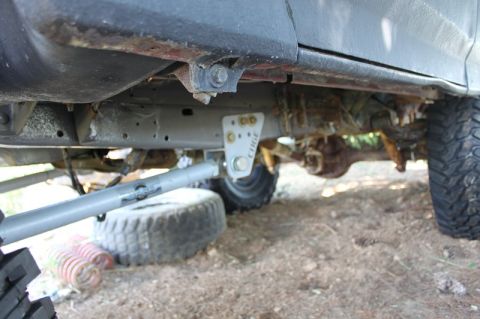 1987 Ford Bronco - Custom suspension components are visible on the undercarriage of this off-road vehicle.