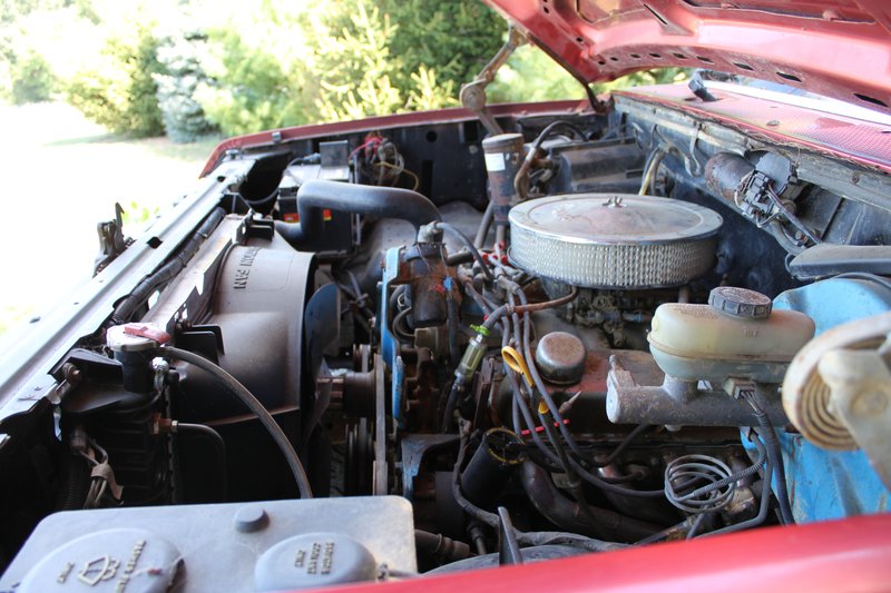 engine bay with V8 engine, air filter, radiator fan, and brake fluid reservoir