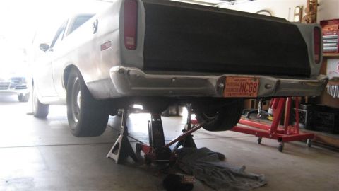 1968 Ford Ranchero - This pickup truck is raised on jack stands for maintenance, revealing its rear axle and exhaust system.