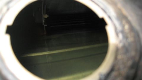 1968 Ford Ranchero - Looking into a fuel tank, showing the interior and some liquid at the bottom.