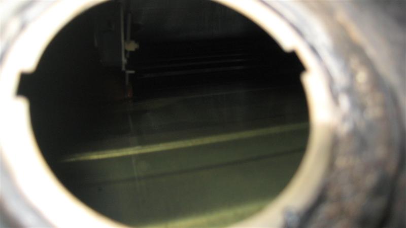 View inside a fuel tank with some liquid at the bottom