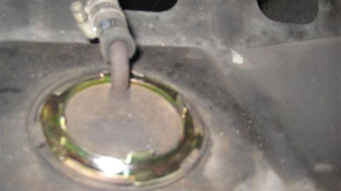 1968 Ford Ranchero - Close-up view of a vehicle's fuel tank sending unit and attached hose.