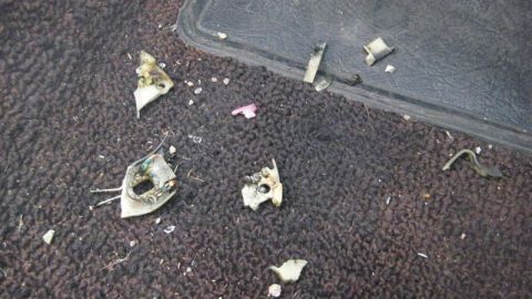 1968 Ford Ranchero - Debris scattered on the carpeted floor of a vehicle, including broken plastic components and wires.