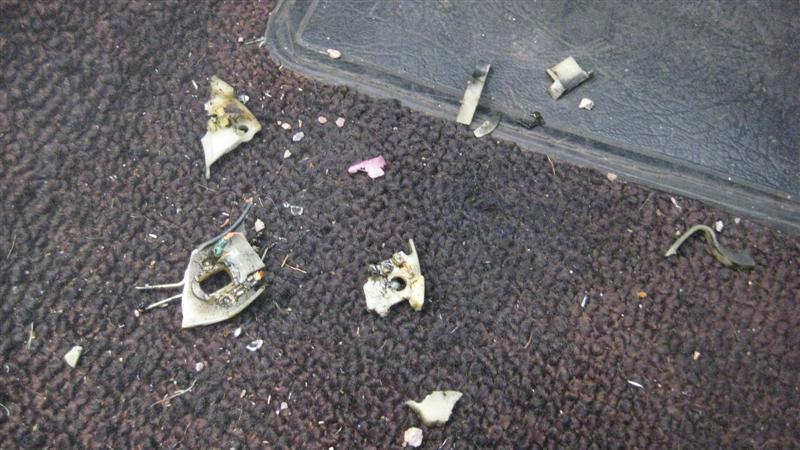 Interior floor debris with broken plastic pieces and wires