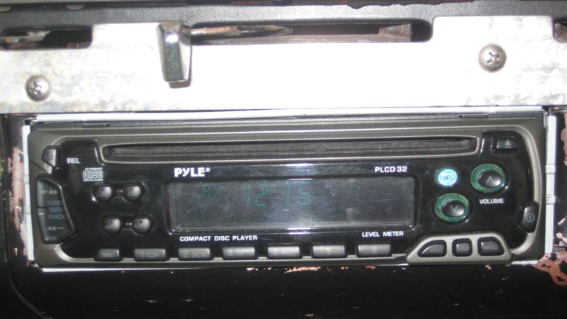 Car stereo with CD player and level meter, labeled PYLE PLCD 32