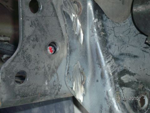 1996 Ford Bronco - A close-up view of a metal bracket, showing signs of modification and wear.